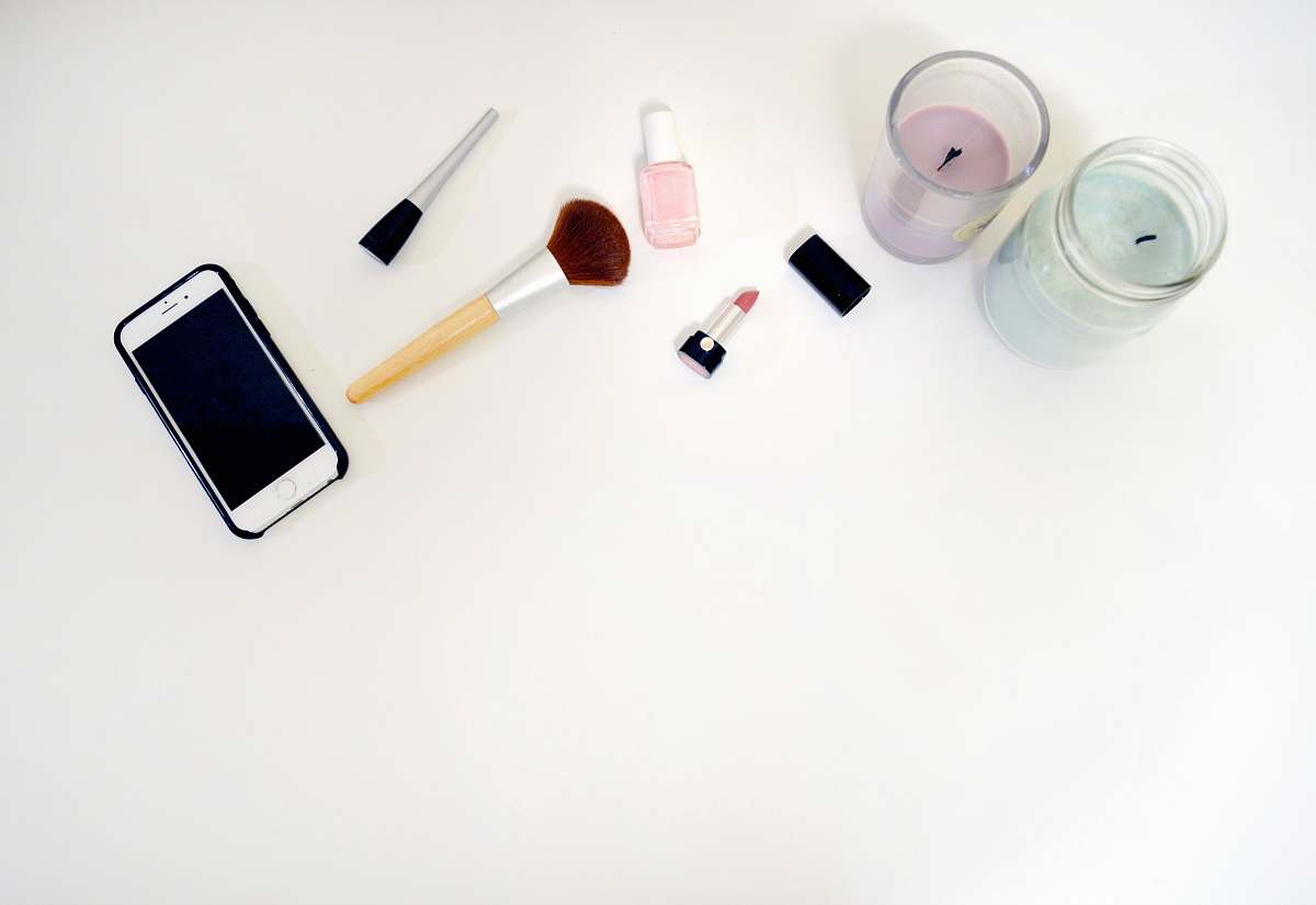 makeup styled stock silver iPhone 6 beside makeup brush flat lay